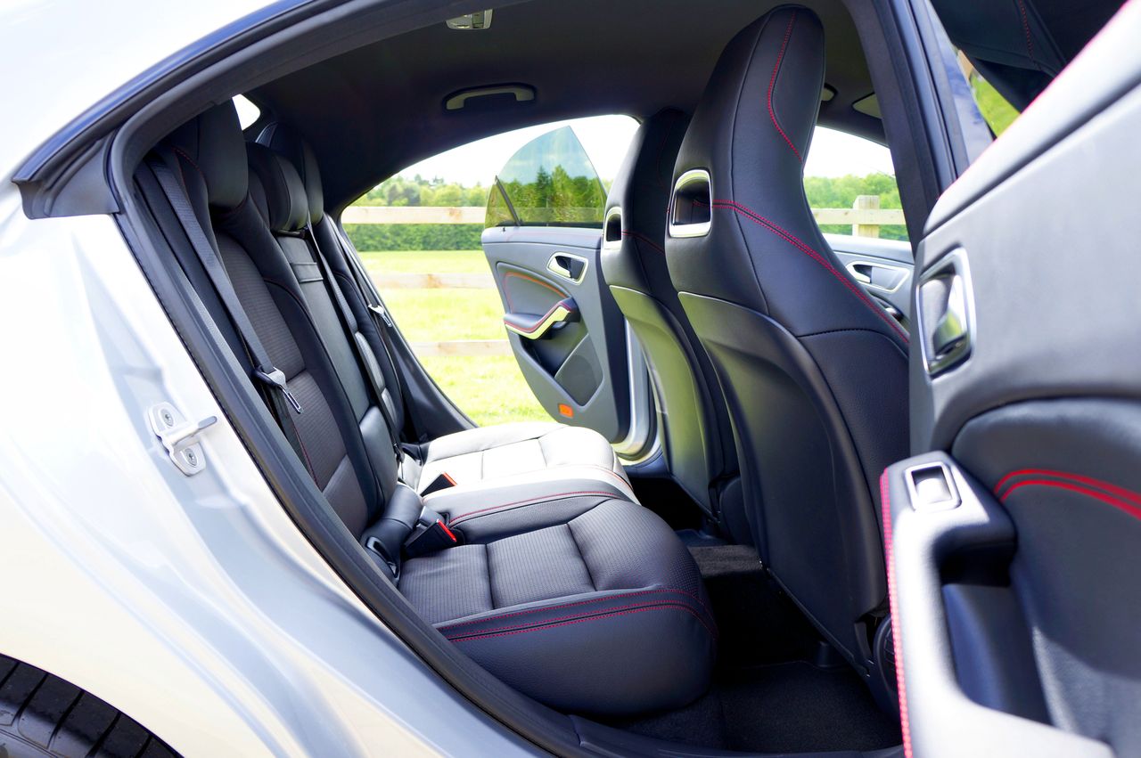 Home Detailed view of a car's interior showing the open back doors, emphasizing design and space.